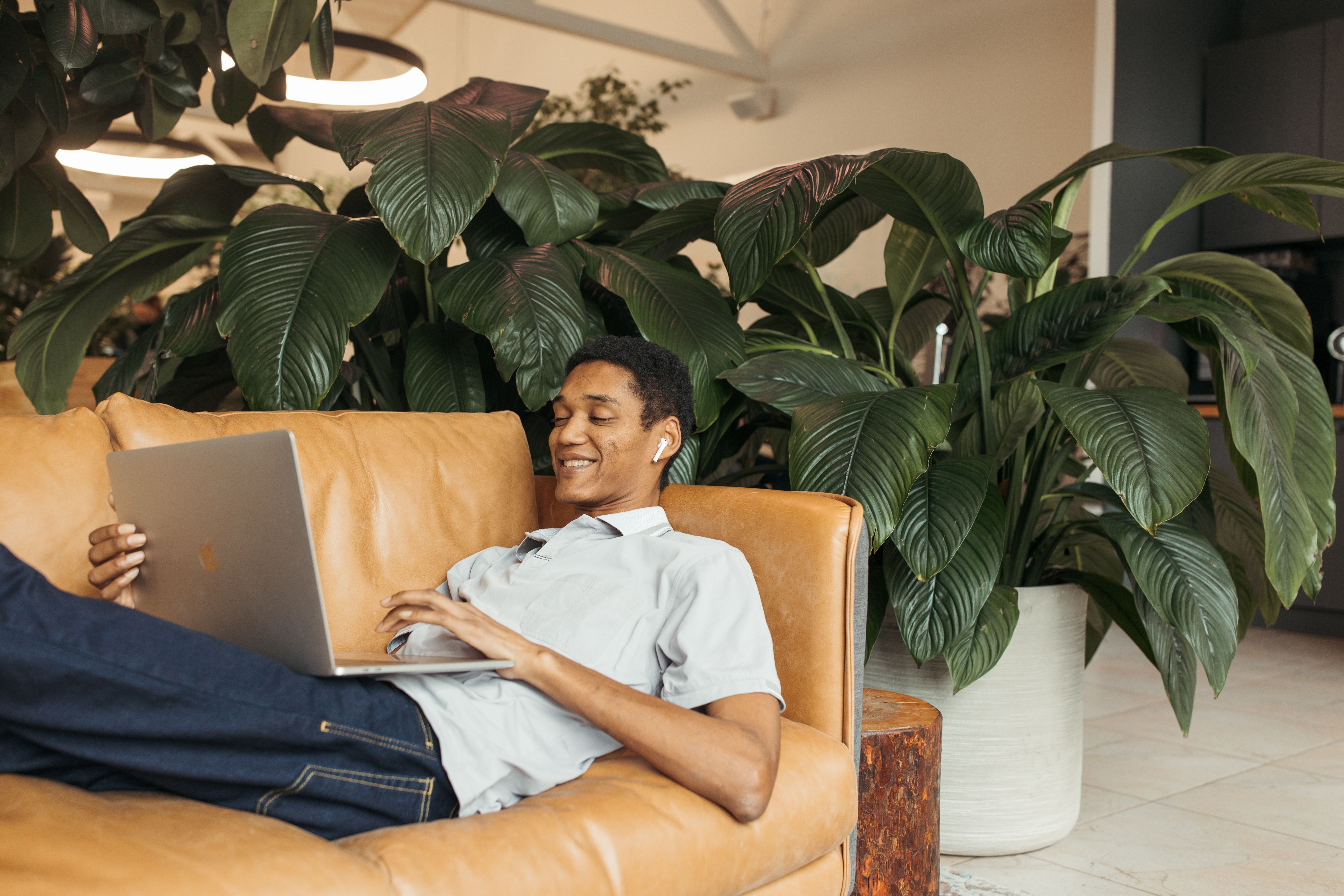 man smiling while using laptop
